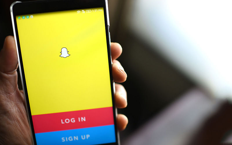 In this file photo taken on 1 March 2017 the Snapchat log-in page is displayed on a mobile phone. Photo: AFP