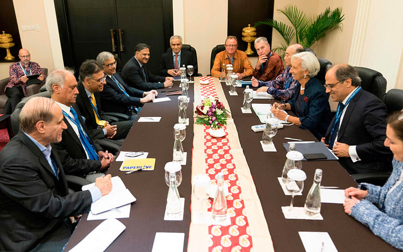 This handout photo taken and released by the International Monetary Fund (IMF) on 11 October 2018 shows IMF managing director Christine Lagarde (3rd R) attending a meeting with Pakistan finance minister Asad Umar (3rd L) at the Bali Convention Centre during the 2018 IMF/World Bank annual meetings in Nusa Dua on the Indonesian resort island of Bali. Photo: AFP