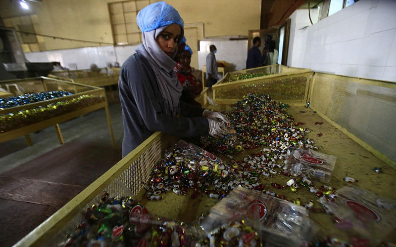 An employee works at the factory of food items and beverages owned by Sudanese businessman Samir Gasim, in the capital Khartoum on 20 September 2018. Photo: AFP