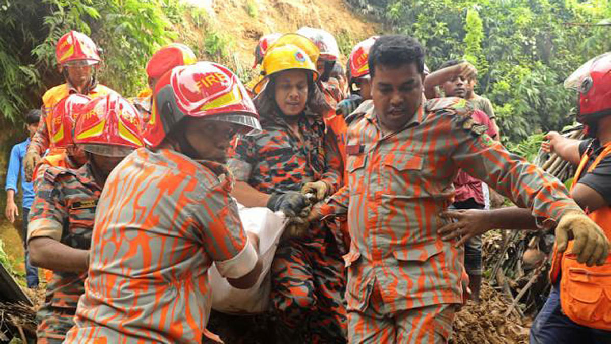 Fire service men recover body of a person killed in Chattogram landslide. Photo: Sourav Das
