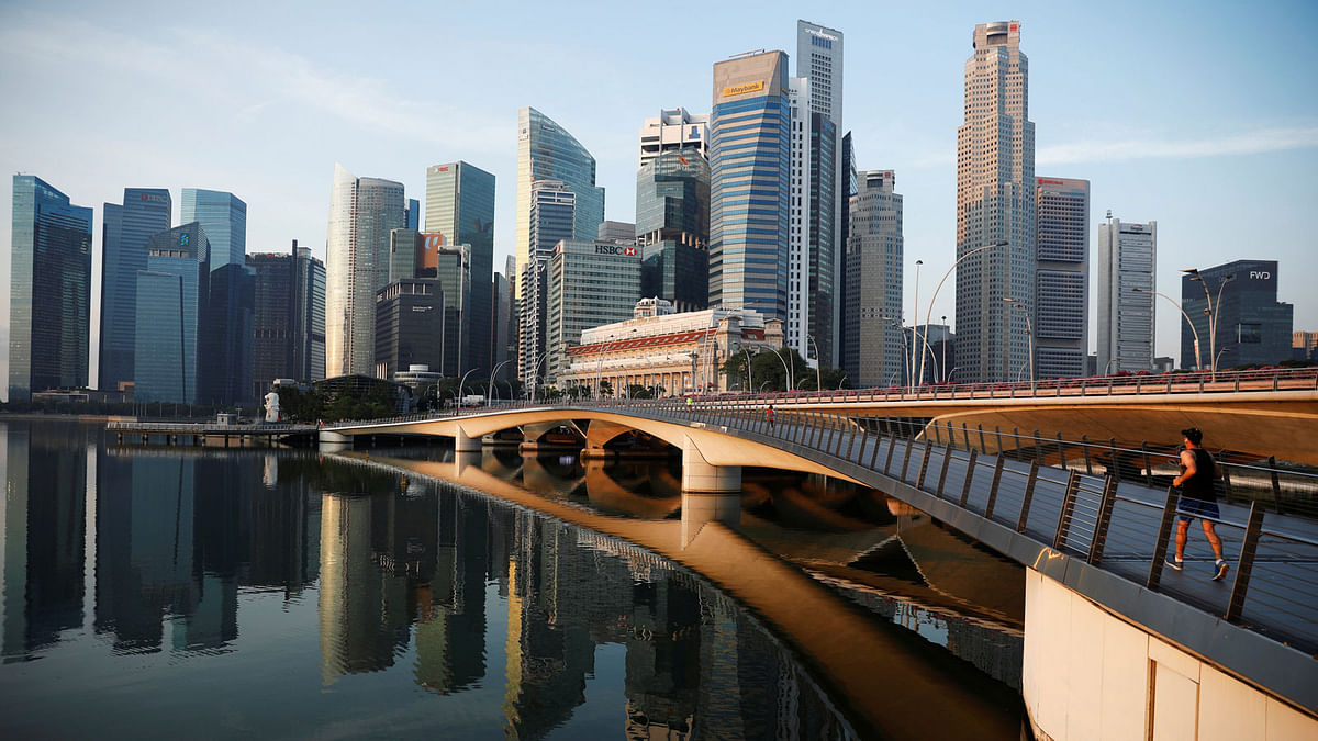 A man jogs past the skyline of Singapore 16 October 2018. Photo: Reuters