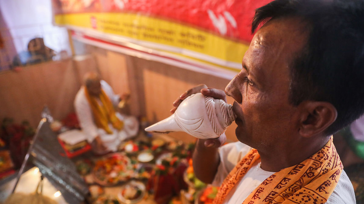 Conch shell blowing at the Shashthi festival on 15 October at Dhakeshwari temple, Dhaka.