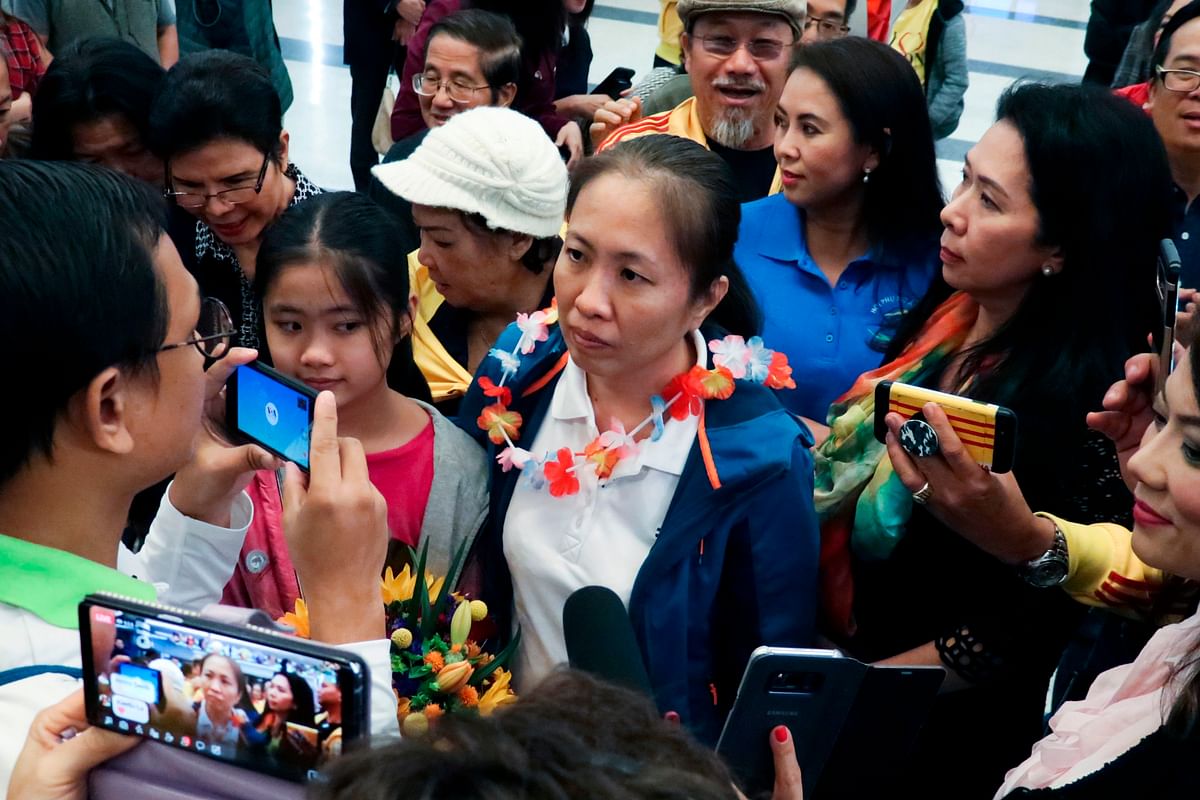 In this handout photo released and taken by Amnesty International on 18 October 2018, Vietnam dissident blogger Nguyen Ngoc Nhu Quynh (C) is surrounded by well-wishers as she arrives at Houston George Bush airport in Houston, Texas. Photo: AFP