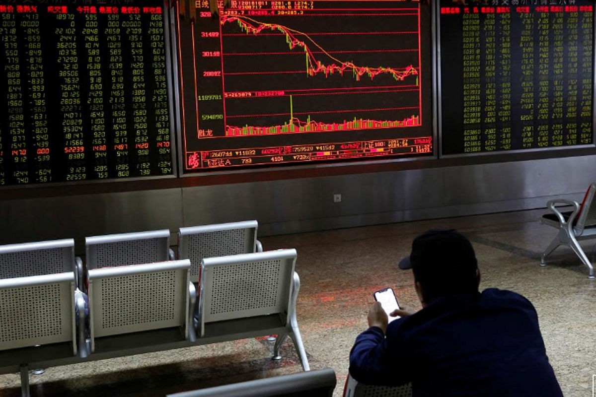 An investor sits in front of displays showing stock information at a brokerage office in Beijing, China on 11 October 2018. -- Photo: Reuters