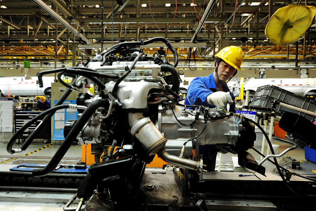 An employee works on an assembly line producing automobiles at a factory in Qingdao. Photo: Reuters