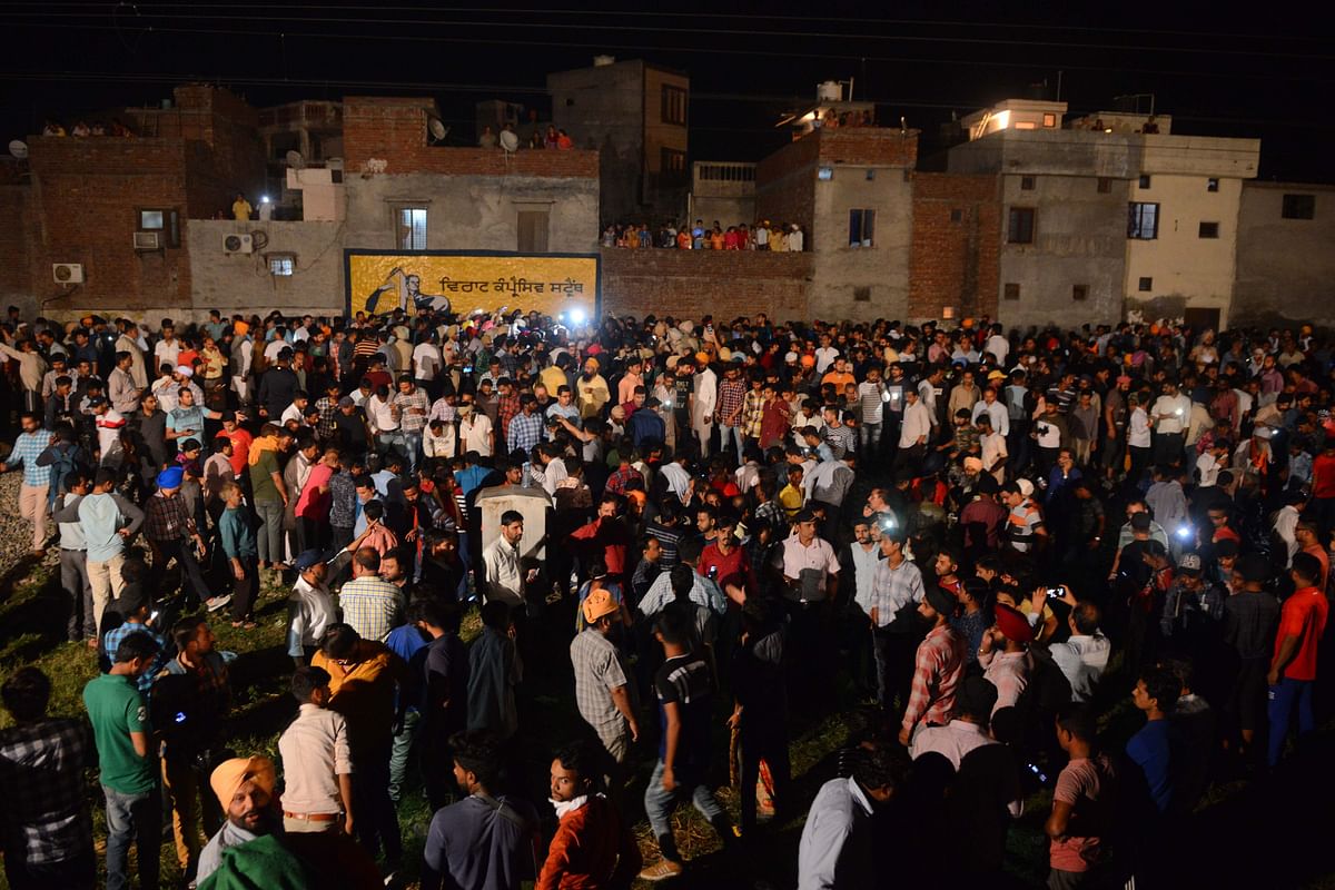Indian relatives and revellers gather around the bodies of the victims of a train accident during the occasion of the Hindu festival of Dussehra in Amritsar on 19 October, 2018. Photo: AFP
