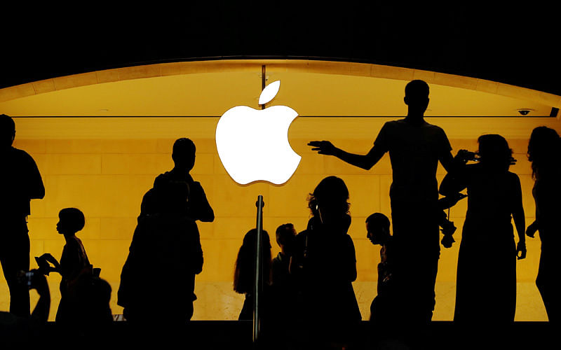 Customers walk past an Apple logo inside of an Apple store at Grand Central Station in New York. Photo: Reuters