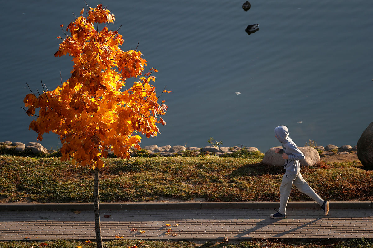 A man runs along the shore of the pond in Minsk, Belarus on 14 October 2018. Photo: Reuters