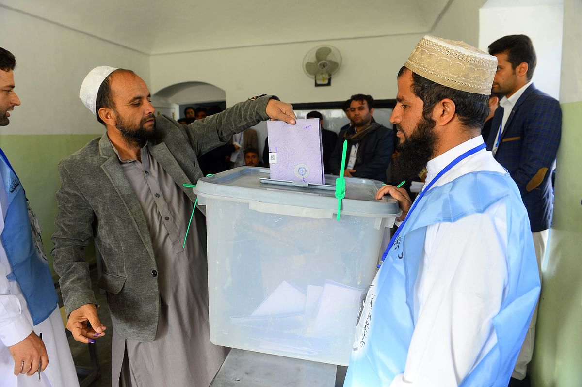 An Afghan voter casts his ballot at a polling centre for the country`s legislative election in Herat province on 20 October. Photo: AFP