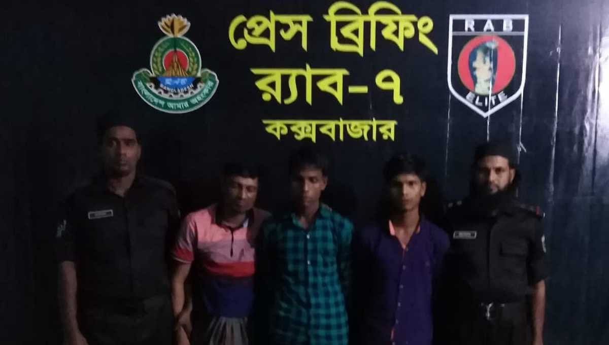 Captured Rohingya youths with RAB members. Photo: UNB