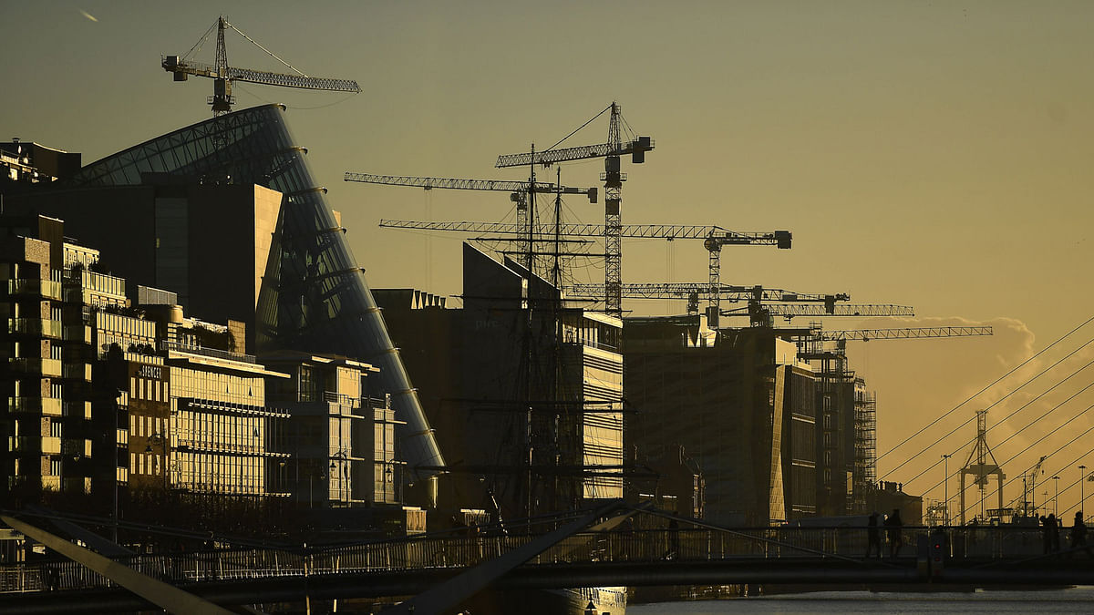 Construction cranes are seen at sunrise in the financial district of Dublin, Ireland on 18 October. Photo: Reuters