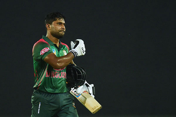 Bangladeshi cricketer Imrul Kayes (R) walks off the field after being dismissed during the first one day international (ODI) cricket match between Bangladesh and Zimbabwe at the Sher-e-Bangla National Cricket Stadium in Dhaka on 21 October 2018. Photo: AFP