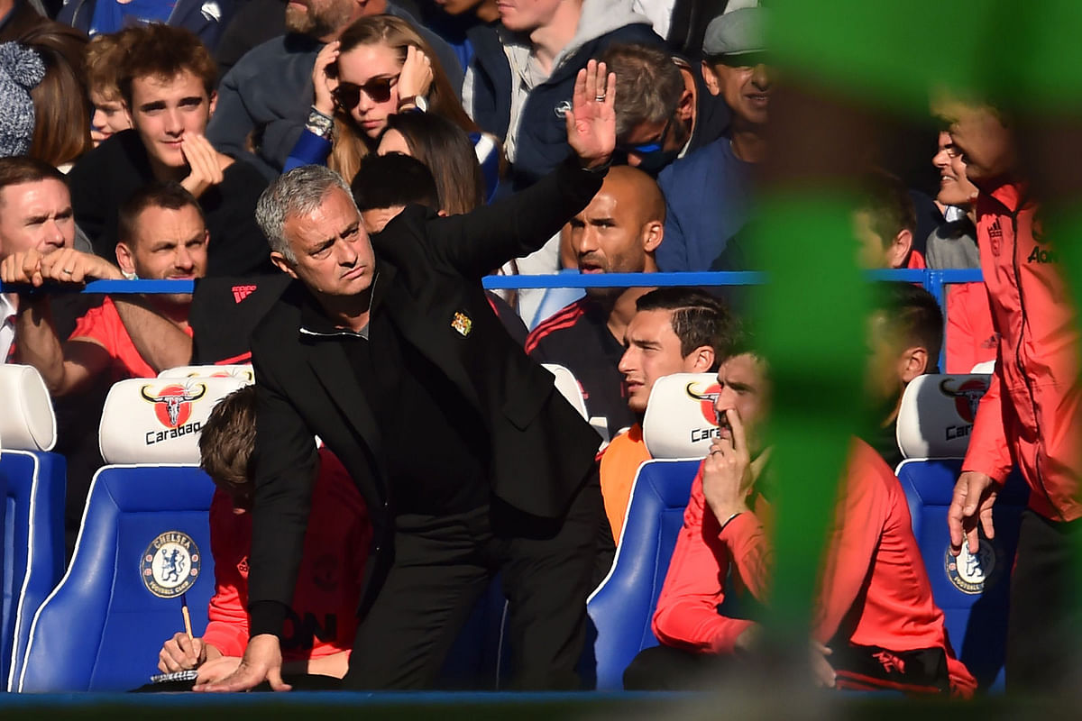 In this file photo taken on October 20, 2018 Manchester United’s Portuguese manager Jose Mourinho gestures on the touchline during the English Premier League football match between Chelsea and Manchester United at Stamford Bridge in London. Chelsea assistant coach Marco Ianni has been charged with improper conduct in a touchline flare-up with Jose Mourinho that led the Football Association to remind the Manchester United manager of his responsibilities. AFP