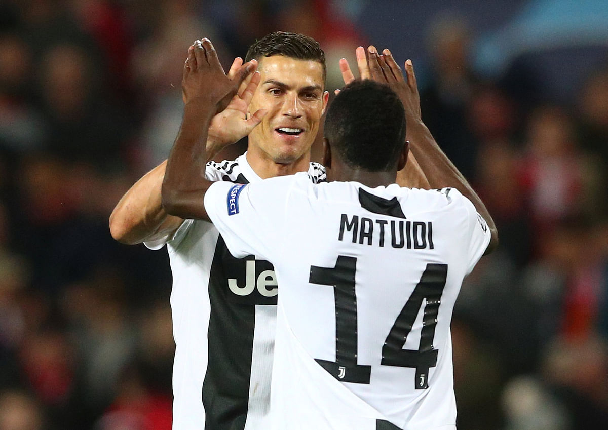 Juventus` Cristiano Ronaldo and Blaise Matuidi celebrate after the match. Reuters