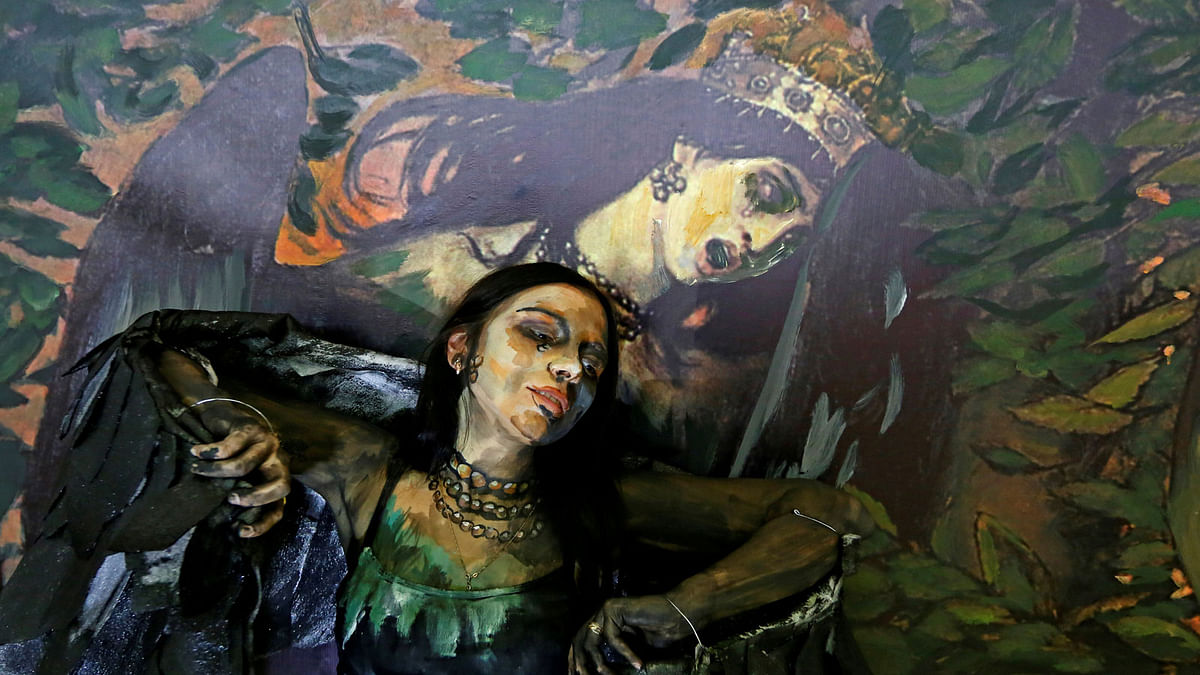 Model Alyona Alekseitseva poses while presenting a body art work by Russian artist Maria Gasanova from her `The Alive Painting` series in front of a reproduction of Victor Vastensov`s `Sirin and Alkonost. A Song of Joy and Sorrow` during the Art Krasnoyarsk annual festival in Krasnoyarsk, Russia on 24 October 2018. Photo: Reuters