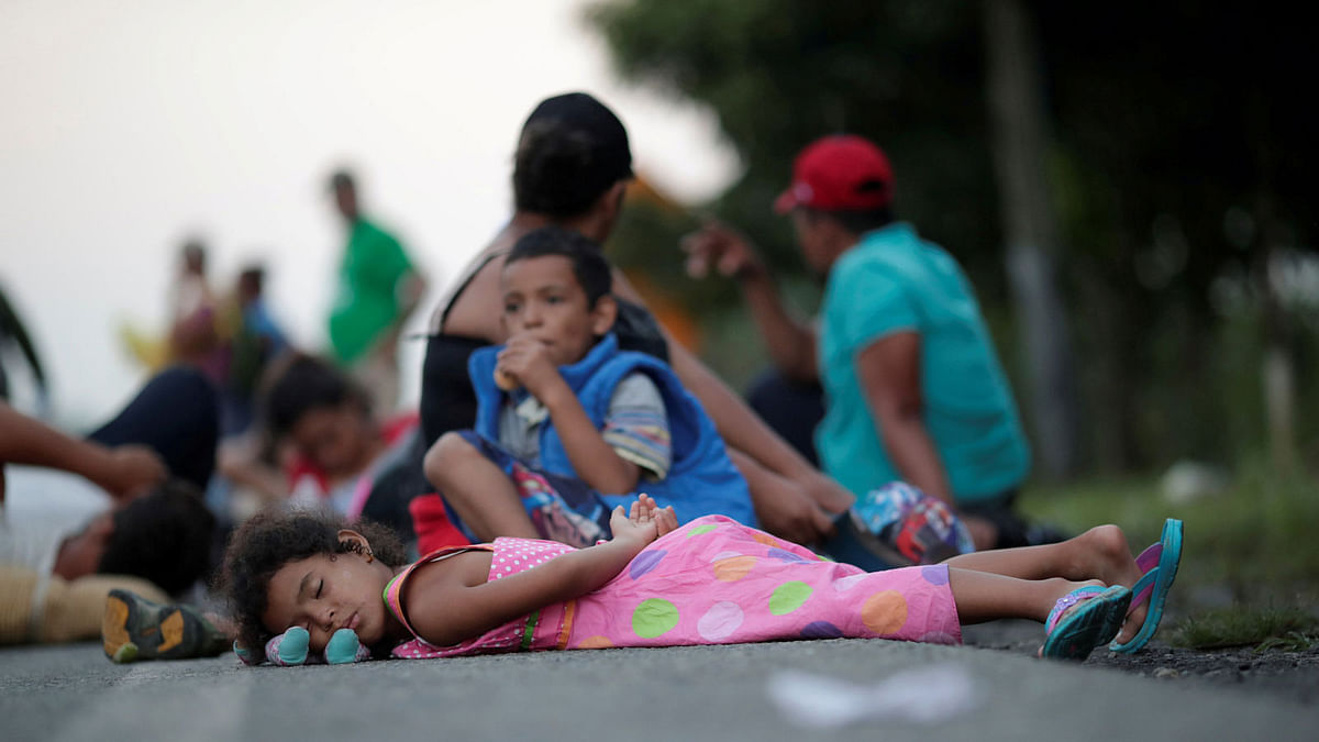 Families rest roadside while traveling with a caravan of thousands of migrants from Central America en route to the United States, on their way to Mapastepec from Huixtla, Mexico, 24 October 2018. Photo: Reuters