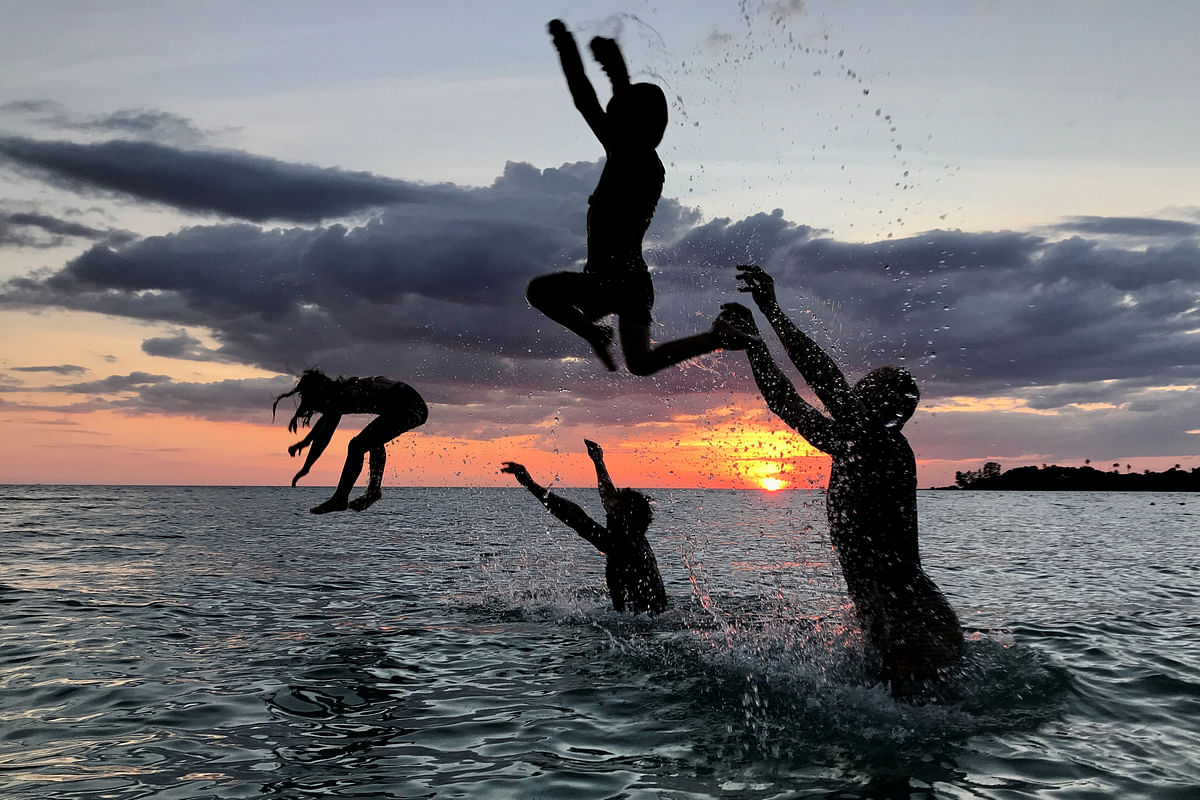 People have fun on a beach during sunset at Ko Kut island in Trat Province, Thailand on 27 October 2018. Photo: Reuters