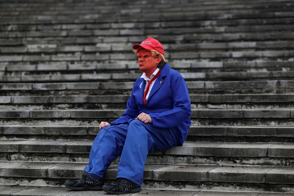 An attendee, dressed as US president Donald Trump, sits on stairs as he attends the MCM London Comic Con at the Excel Centre in London, Britain on 26 October 2018. Photo: Reuters