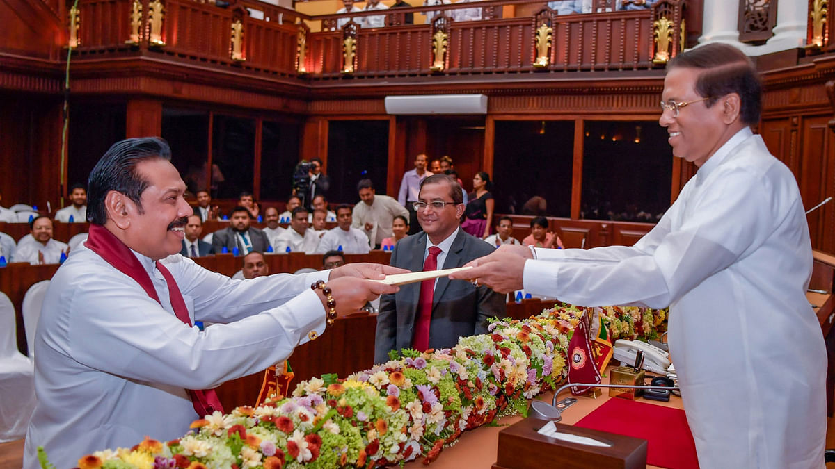 Sri Lanka`s newly appointed PM Mahinda Rajapaksa is sworn in as the Minister of Finance and Economic Affairs before President Maithripala Sirisena in Colombo. Photo: Reuters