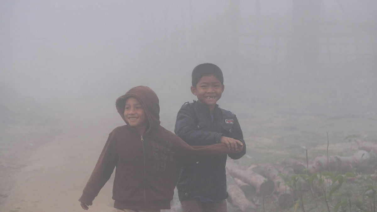 Two children in the mist at Saapchhari Moddhopara, Rangamati on 30 october. Photo: Supriya Chakma
