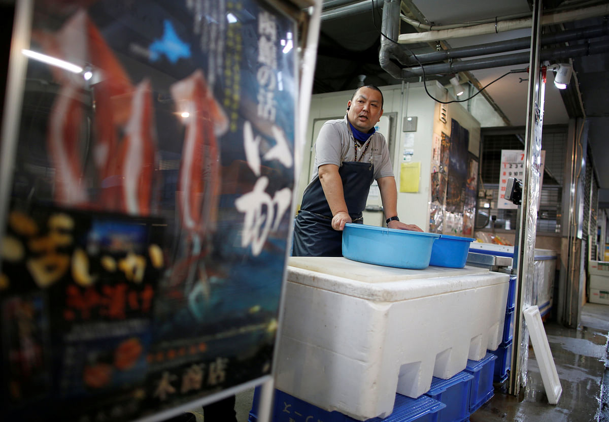 Atsushi Kobayashi, a live squid trader, stands at his shop in Ota Wholesale Market in Tokyo, Japan on 23 July. Picture taken on 23 July. Photo: Reuters