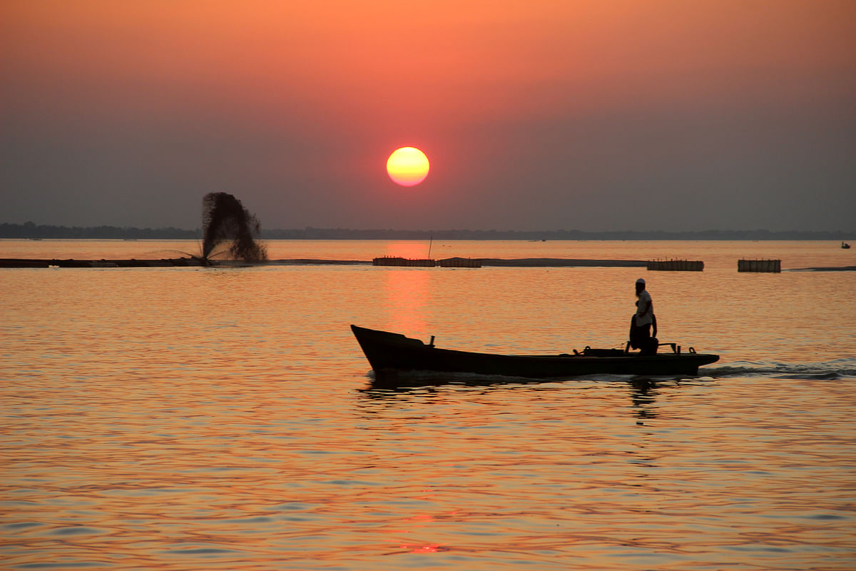 A fisherman returns home on his boat during the sunset at river Padma in Rajbari on 2 November. Photo: Touhidi Hassan
