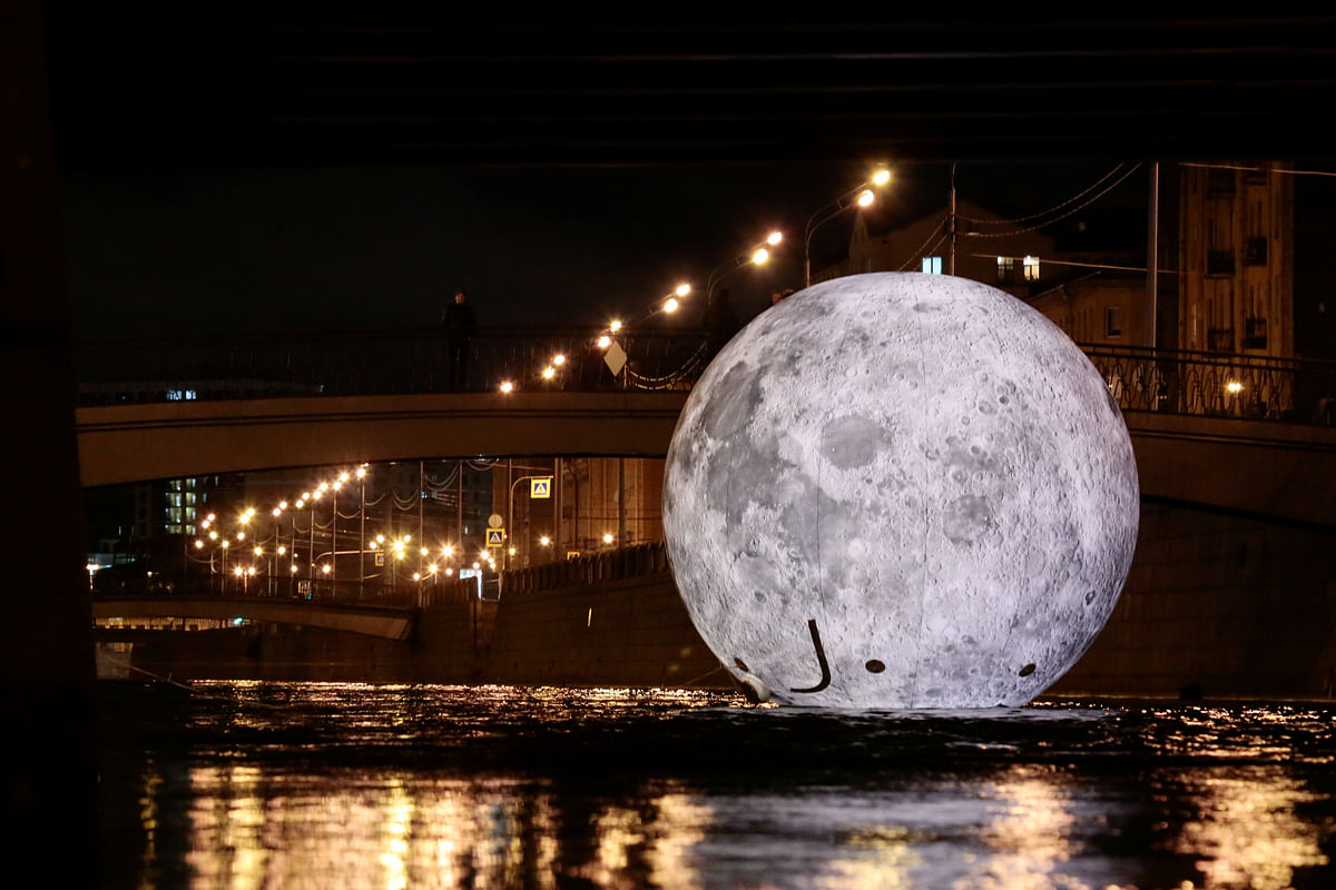 A giant ball decorated with images of the moon`s surface, an installation for the `Festival of Lights`, is seen in the water of Obvodny channel in Saint Petersburg, Russia on 3 November 2018. Photo: Reuters