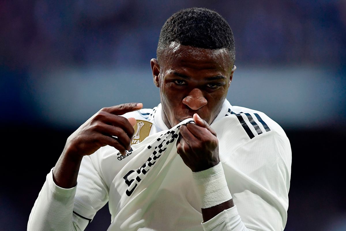 Real Madrid`s Brazilian forward Vinicius Junior kisses his jersey`s badge to celebrate Valladolid`s own goal during the Spanish league football match between Real Madrid CF and Real Valladolid FC at the Santiago Bernabeu stadium in Madrid on 3 November 2018. Photo: AFP