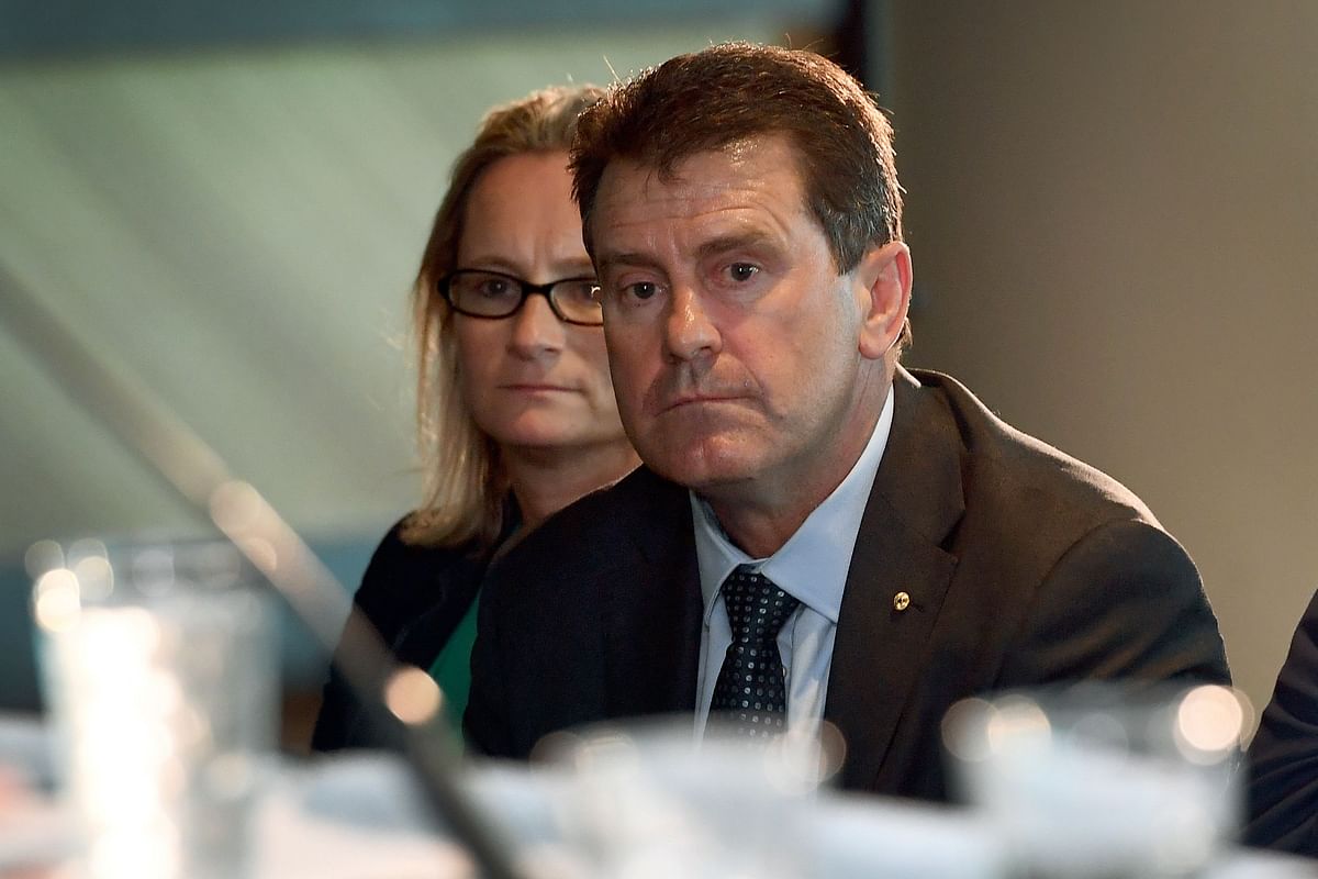 A photo taken on 29 October 2018 shows former Australian cricket captain and Cricket Australia (CA) director Mark Taylor listening to then-CA chairman David Peever speaking during a press conference in Melbourne. Photo: AFP