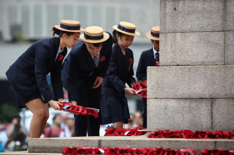 School children lay wreaths during a Remembrance Day ceremony honouring members of the armed forces who died in the line of duty at the Cenotaph marking the 100th anniversary of the end of World War I in Hong Kong on 11 November 2018. Photo: AFP