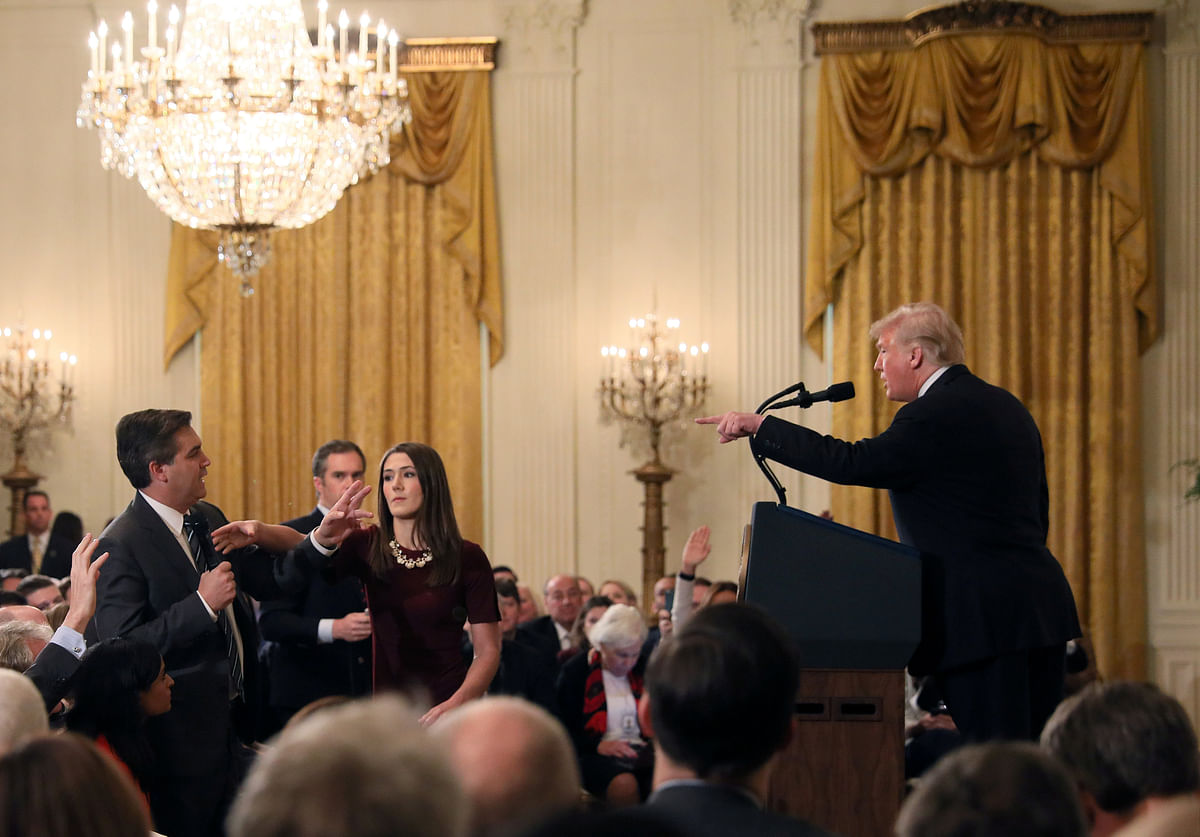 A White House staff member reaches for the microphone held by CNN`s Jim Acosta as he questions US president Donald Trump during a news conference following Tuesday`s midterm US congressional elections at the White House in Washington, US, on 7 November 2018. Photo: Reuters