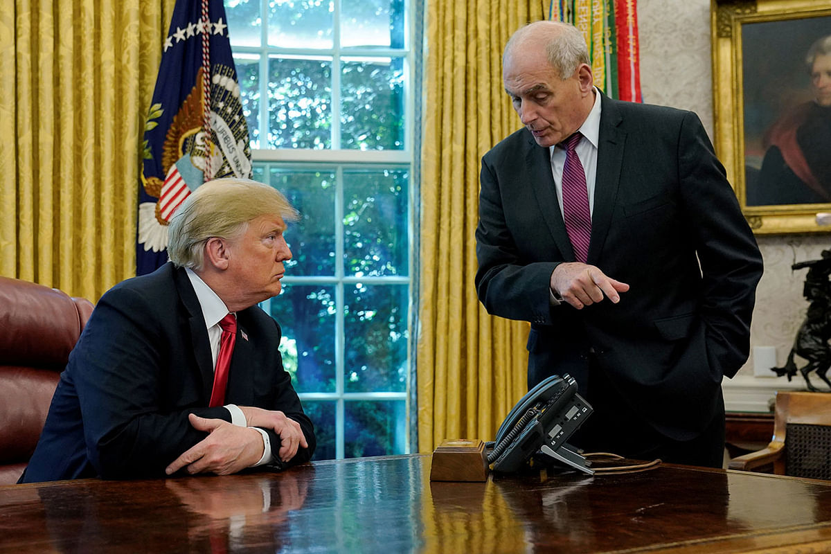 US president Donald Trump speaks to White House Chief of Staff John Kelly after an event with reporters in the Oval Office at the White House in Washington, US on 10 October. Photo: Reuters