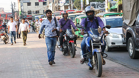 Motorcycle riders, violating traffic rules to save time, drive on the footpaths along Karwan Bazar, Dhaka on 13 November. Photo: Sabrina Yesmin
