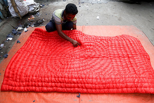 On the eve of winter, a worker busy making a quilt at Mohammadpur, Dhaka on 13 November. Each piece sells at Tk 800 to 1,500. Photo: Sabrina Yesmin