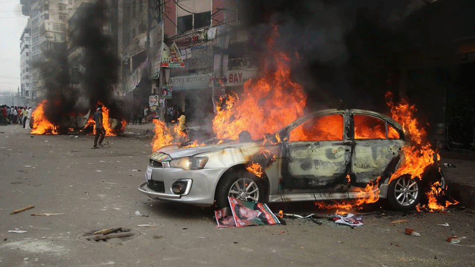 A private car was torched during the clash between opposition BNP leaders and activists and police in front of BNP’s Naya Paltan Central office in Dhaka on Wednesday. Photo: Abdus Salam
