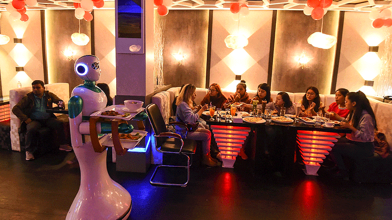 In this picture taken on 26 October 2018, a Nepali-made robot waiter delivers food to customers at Naulo restaurant in Kathmandu. Photo: AFP