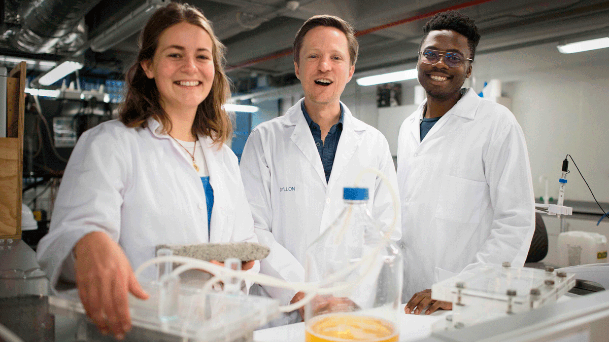 Suzanne Lambert, Dr Dyllon Randall and Vukheta Mukhari, developers of the world`s first bio-brick which uses human urine as one of the binding components, pose in the lab at the Department of Civil Engineering at the University of Cape Town (UCT) on 2 November 2018 in Cape Town. In one of the latest innovations in the search for eco-friendly building materials, South African university researchers have created bricks using human urine. The first of their kind in the world, the bio-bricks hold out the prospect of a sustainable alternative to standard clay and concrete bricks, they hope. Photo: AFP