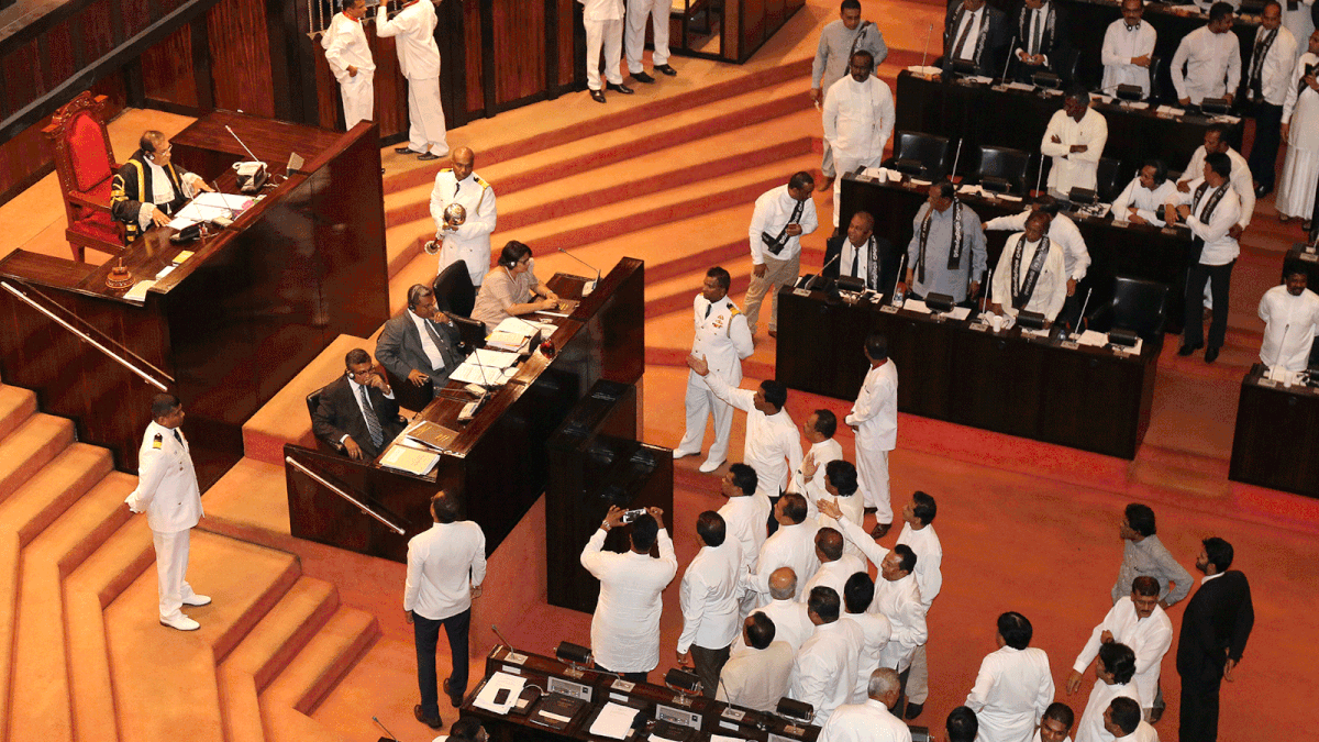 Sri Lanka`s parliament members argue in front of Speaker of the Parliament Karu Jayasuriya during the parliament session in Colombo, Sri Lanka on 14 November 2018. Photo: Reuters