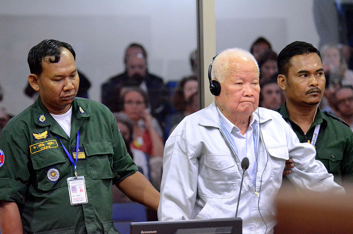 This handout photo taken and released by the Extraordinary Chambers in the Courts of Cambodia (ECCC) on 16 November, 2018 shows former Khmer Rouge leader head of state Khieu Samphan stands during his verdict in court at the ECCC in Phnom Penh. Two senior Khmer Rouge leaders were sentenced to life imprisonment for genocide for their part in the regime`s 1975-1979 reign of terror, a UN-backed war crimes court said on 16 November in a historic ruling. Photo: AFP