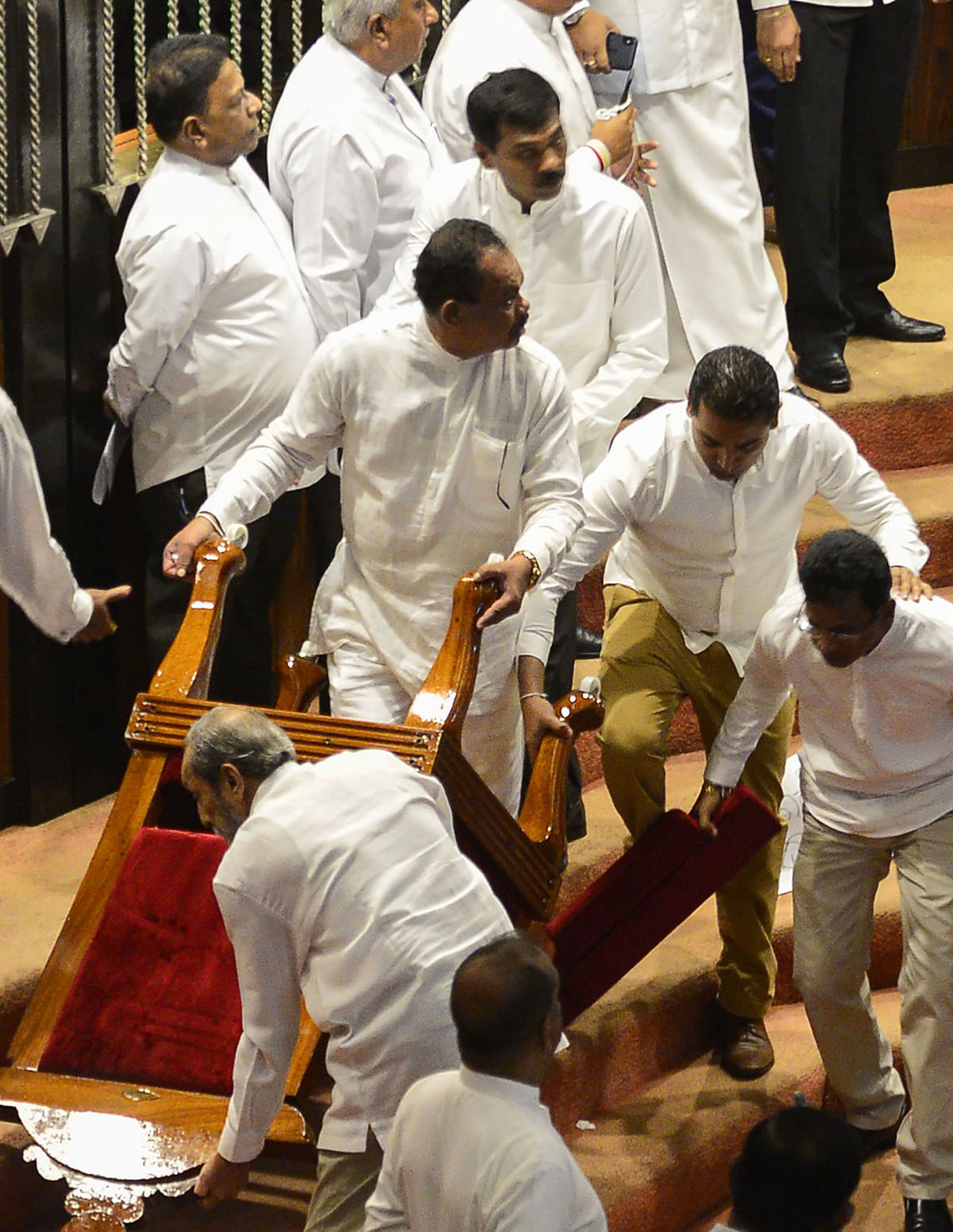 Members of the Sri Lankan parliament backing former president and currently appointed prime minister Mahinda Rajapakse drag away the parliament speaker`s chair in Colombo on 16 November, 2018. Photo: AFP