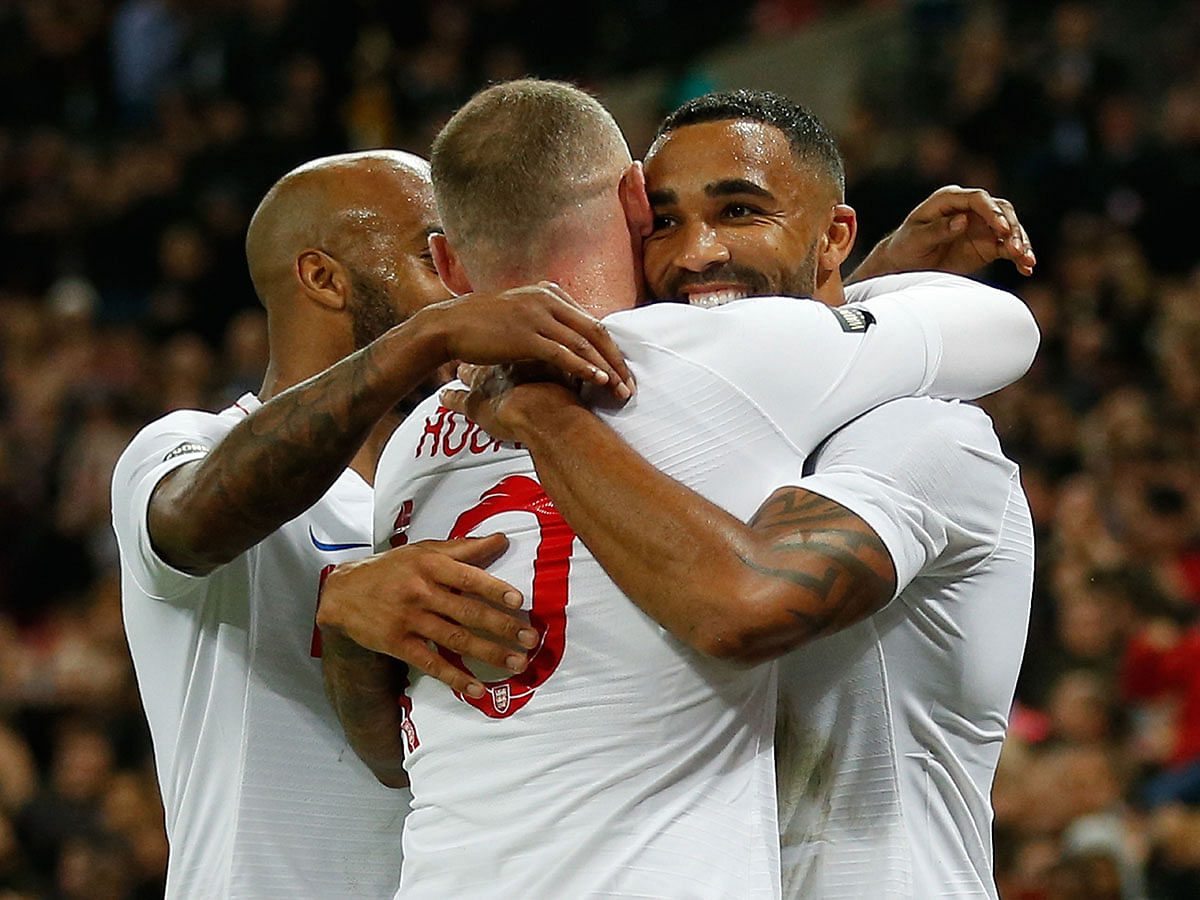 England`s striker Callum Wilson (R) celebrates scoring their third goal with England`s striker Wayne Rooney (C) and England`s midfielder Fabian Delph (L) during the international friendly football match between England and the United States at Wembley stadium in north London on 15 November 2018. Photo: AFP