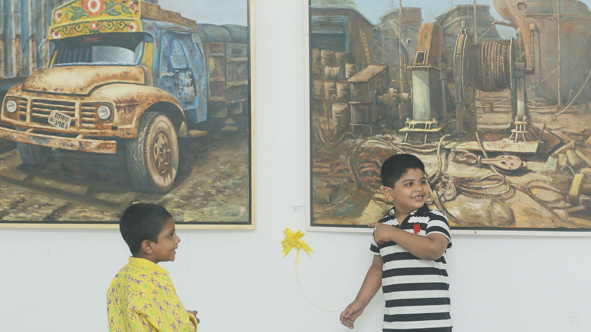Two children at the annual artwork exhibition organised by the drawing and painting department of the fine arts faculty at Dhaka University on 15 November. Photo: Abdus Salam