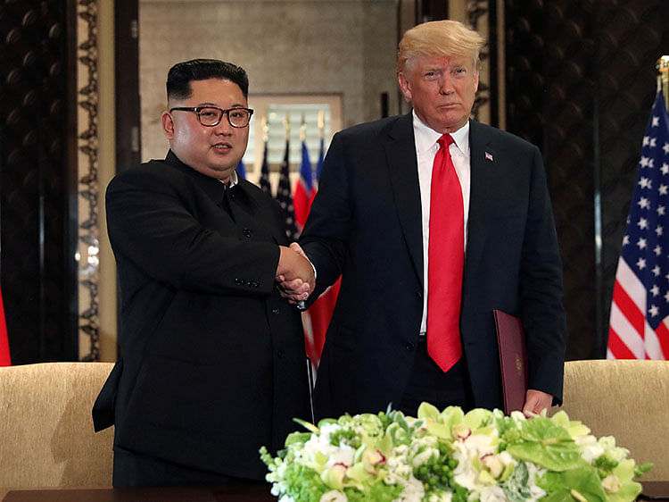 US president Donald Trump shakes hands with North Korea`s leader Kim Jong Un after they signed documents that acknowledged the progress of the talks and pledge to keep momentum going, after their summit at the Capella Hotel on Sentosa island in Singapore on 12 June. Photo: Reuters
