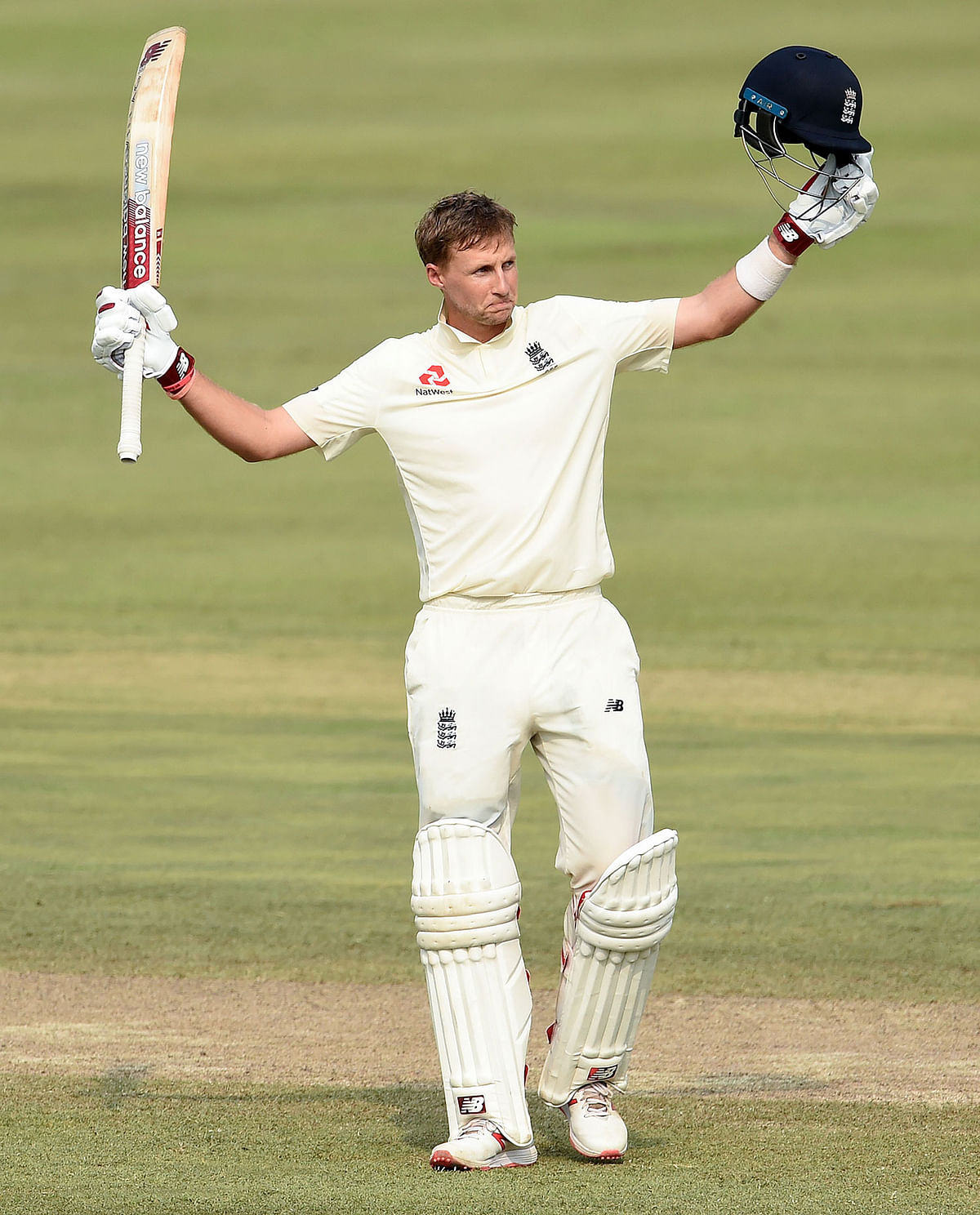 England’s captain Joe Root raises his bat and helmet in celebration after scoring a century (100 runs) during the third day of the second Test match between Sri Lanka and England at the Pallekele International Cricket Stadium in Kandy on 16 November, 2018. Photo: AFP