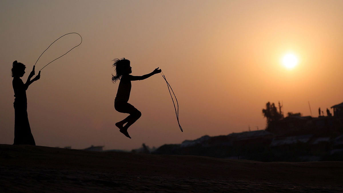Rohingya refugee children are silhouetted as they play with jumping ropes at Balukhali camp in Cox’s Bazar, Bangladesh, 16 November, 2018. Photo: Reuters