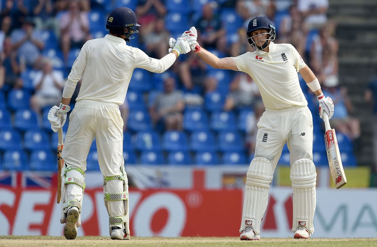 England`s captain Joe Root (R) and Ben Foakes gestures during the third day of the second Test match between Sri Lanka and England at the Pallekele International Cricket Stadium in Kandy on 16 November 2018. Photo: AFP