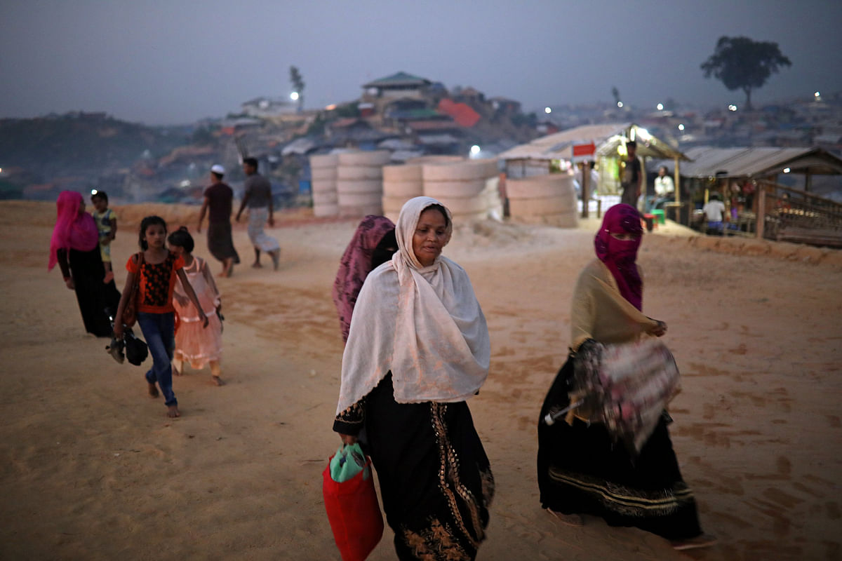 Rohingya refugees walk along the road in the evening at Balukhali camp in Cox’s Bazar, Bangladesh, on 16 November 2018. Photo: Reuters