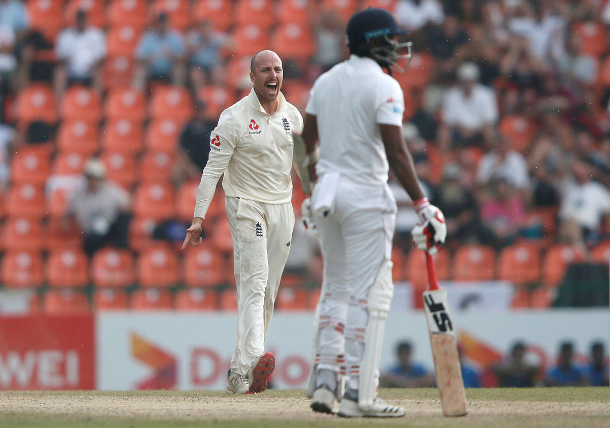 England`s Jack Leach (R) celebrates with his teammates after taking the wicket of Sri Lanka`s Dilruwan Perera in Pallekele, Sri Lanka on 17 November. Photo: Reuters  England sniff series victory
