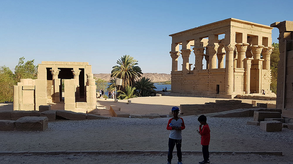 Aaryan and Aariz pose with the lion statues at the entrance of Philae temple