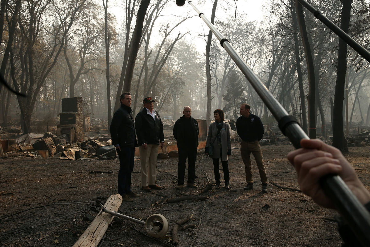 US president Donald Trump speaks to reporters while visiting the charred wreckage of Skyway Villa Mobile Home and RV Park with Governor-elect Gavin Newsom (L), FEMA head Brock Long (R), Paradise Mayor Jody Jones (2nd R) and Governor Jerry Brown in Paradise, California, US, 17 November 2018. Photo: Reuters